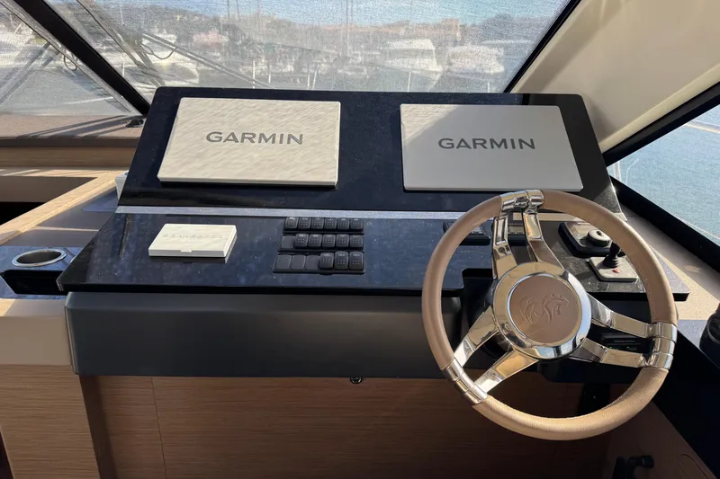  Yacht Photos Pics Helm of 2020 Monte Carlo 52 yacht with Garmin navigation displays and steering wheel.