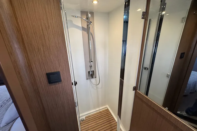  Yacht Photos Pics Modern shower in 2020 Monte Carlo 52 yacht with wooden accents and sleek design.