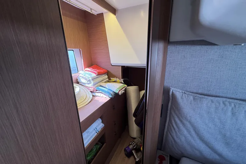  Yacht Photos Pics Interior of 2020 Monte Carlo 52 yacht with storage and folded linens.