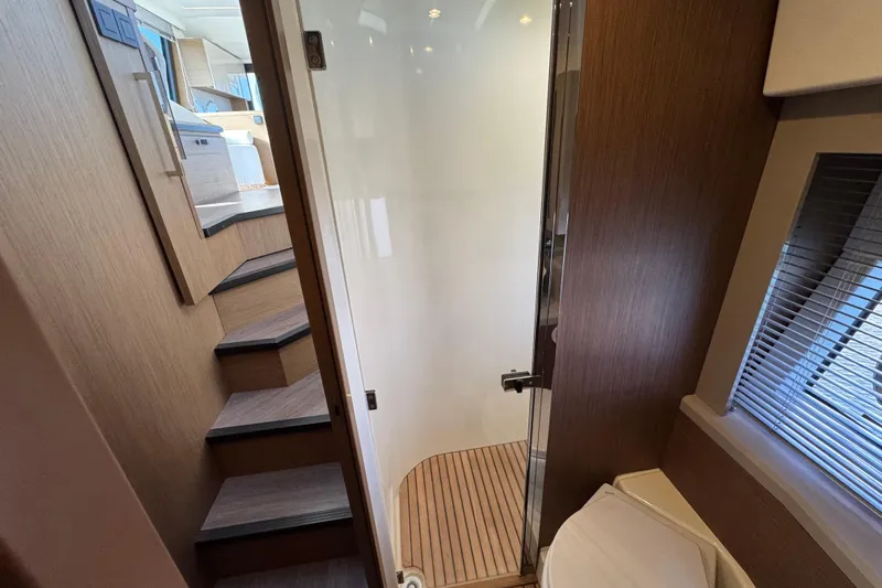  Yacht Photos Pics Interior of 2020 Monte Carlo 52 yacht, featuring wooden stairs and modern design elements.