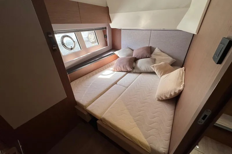  Yacht Photos Pics Luxurious cabin interior of 2020 Monte Carlo 52 yacht with cozy bedding and porthole windows.
