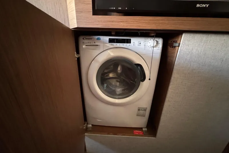  Yacht Photos Pics Compact washing machine in a wooden cabinet on a Monte Carlo 52 yacht, 2020 model.