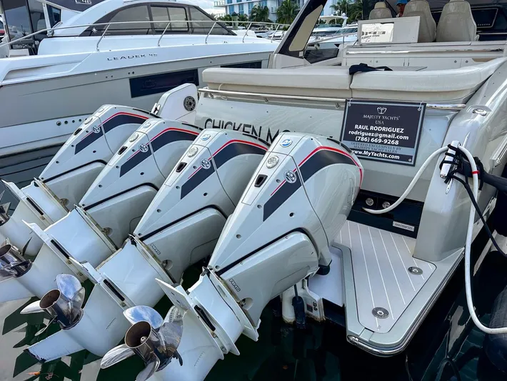  Yacht Photos Pics 2023 Azimut Verve 47 yacht with triple outboard engines docked at marina.
