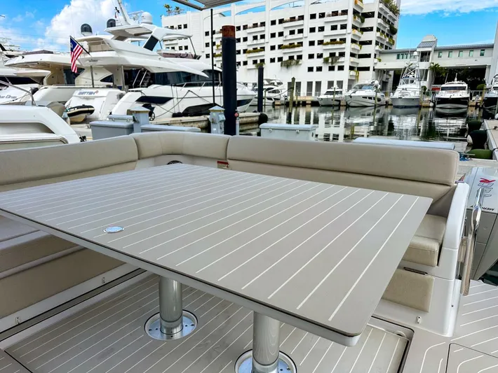  Yacht Photos Pics 2023 Azimut Verve 47 yacht with elegant outdoor seating and table at marina.