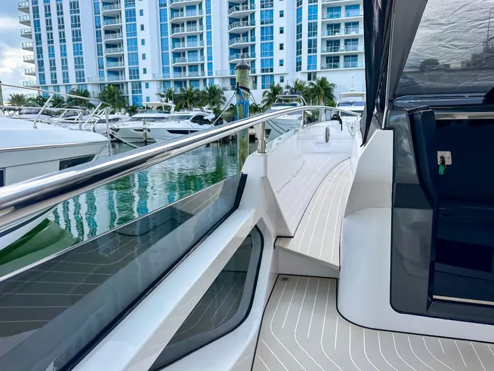  Yacht Photos Pics 2023 Azimut Verve 47 yacht docked near modern waterfront buildings.