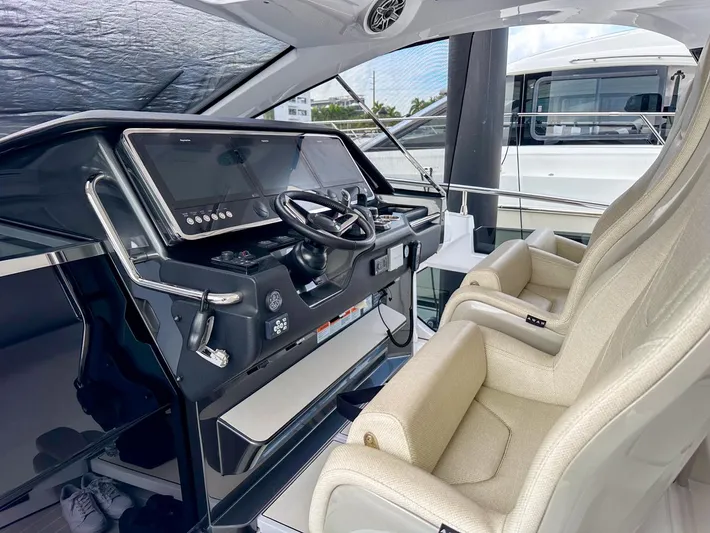  Yacht Photos Pics 2023 Azimut Verve 47 helm with modern controls and luxurious seating.