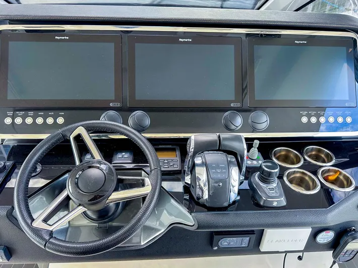  Yacht Photos Pics Control panel of 2023 Azimut Verve 47 yacht with steering wheel and digital displays.
