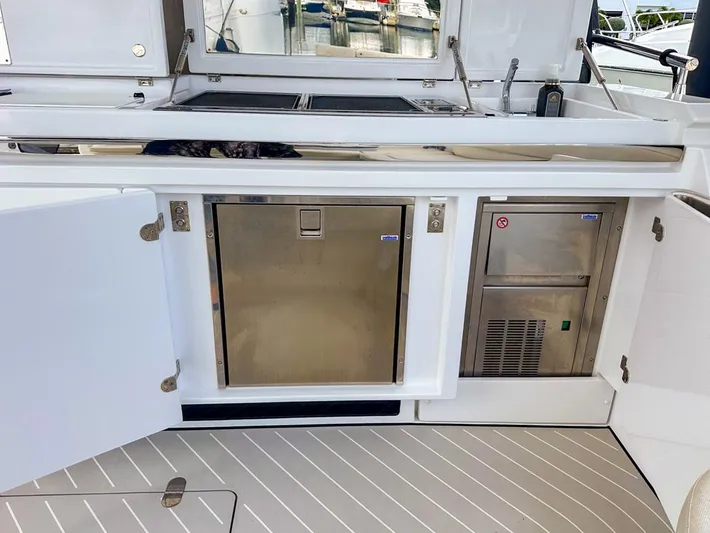  Yacht Photos Pics 2023 Azimut Verve 47 yacht kitchen area with stainless steel appliances and sleek design.