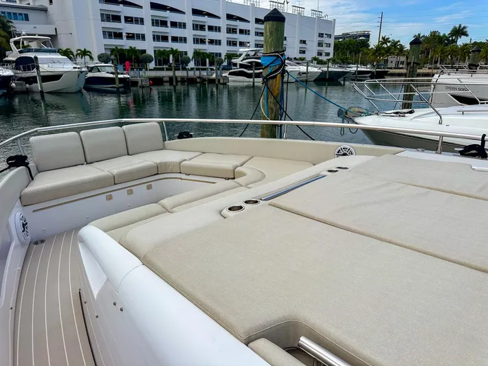  Yacht Photos Pics 2023 Azimut Verve 47 yacht with spacious deck seating in a marina.