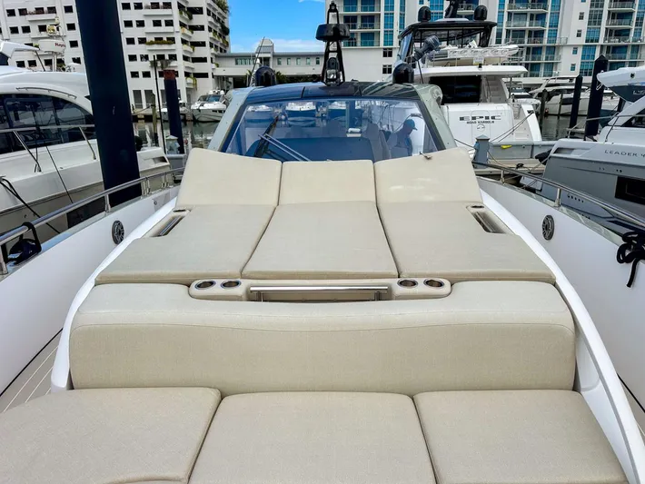  Yacht Photos Pics 2023 Azimut Verve 47 yacht with luxurious sunbathing deck in marina setting.