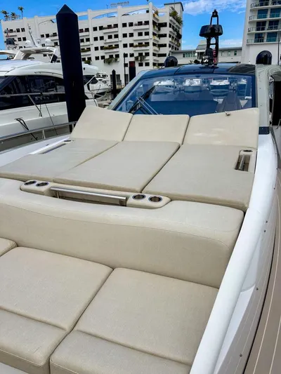  Yacht Photos Pics 2023 Azimut Verve 47 luxury yacht with spacious sunbathing deck in marina setting.