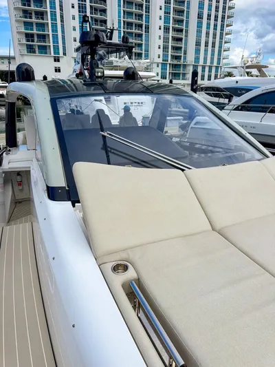  Yacht Photos Pics 2023 Azimut Verve 47 luxury yacht docked near modern buildings.