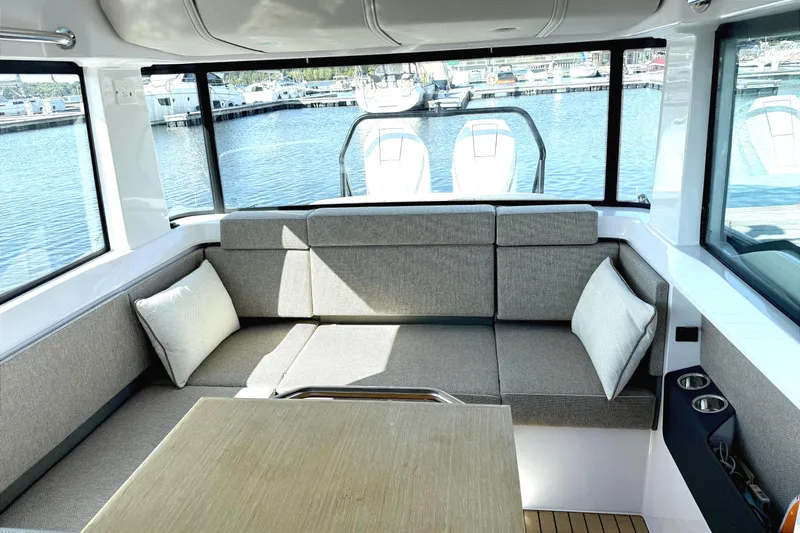  Yacht Photos Pics Interior of 2025 Axopar 37 XC CROSS CABIN with comfortable seating and marina view.