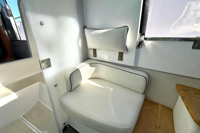  Yacht Photos Pics Interior of Axopar 37 XC CROSS CABIN 2025 with beige seating area.