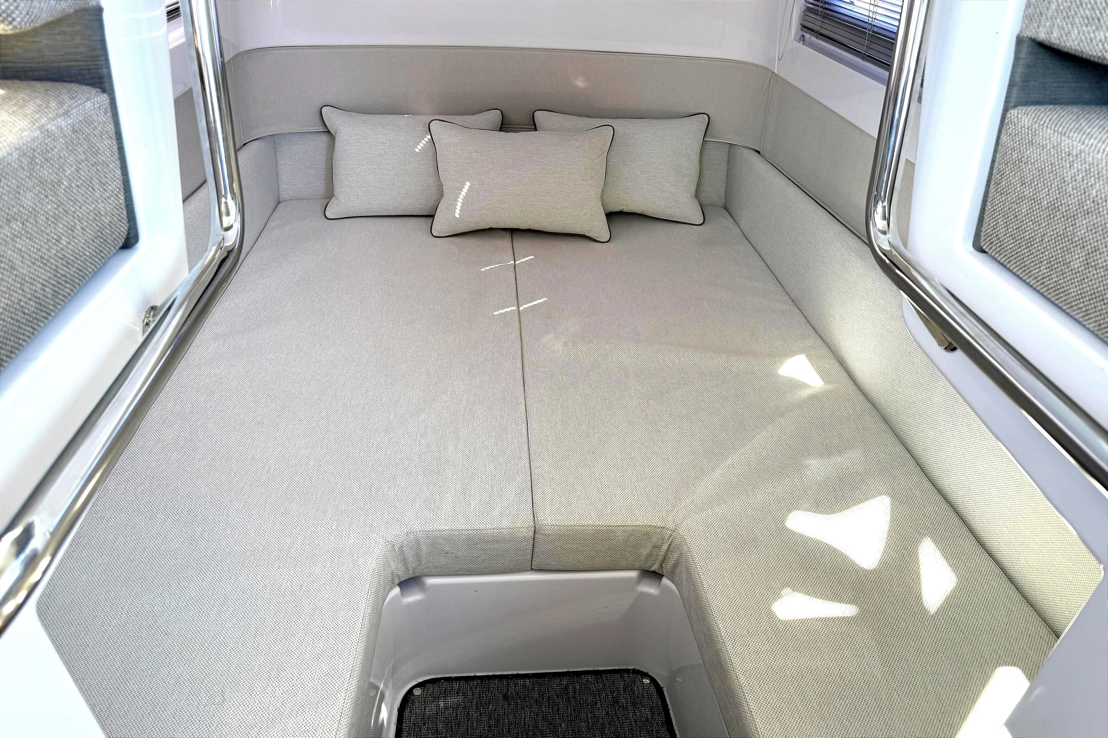  Yacht Photos Pics 2025 Axopar 37 XC CROSS CABIN interior with cozy bed and cushions.