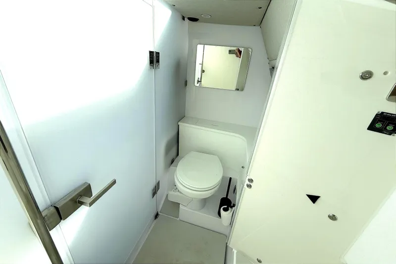  Yacht Photos Pics 2025 Axopar 37 XC CROSS CABIN bathroom with modern fixtures and compact design.
