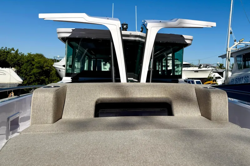  Yacht Photos Pics 2025 Axopar 37 XC CROSS CABIN boat with open doors and cushioned seating.