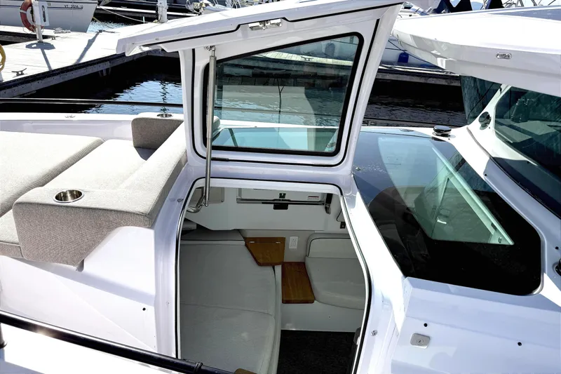  Yacht Photos Pics 2025 Axopar 37 XC CROSS CABIN boat interior with open cabin door and seating area.