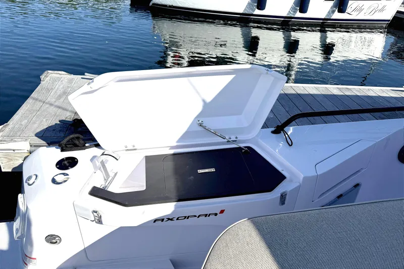 Yacht Photos Pics Open storage compartment on 2025 Axopar 37 XC CROSS CABIN boat at dockside.