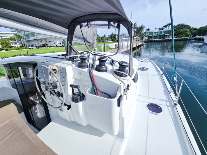 Breathing Room Yacht Photos Pics 2014 Fountaine Pajot Lipari 41 catamaran helm with steering wheel and winches, docked by water.