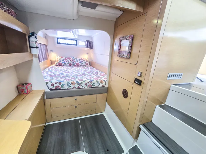 Breathing Room Yacht Photos Pics Cabin interior of 2014 Fountaine Pajot Lipari 41 catamaran with cozy bed and wooden furnishings.