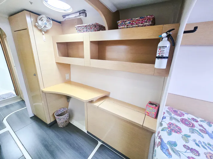 Breathing Room Yacht Photos Pics Interior of 2014 Fountaine Pajot Lipari 41 catamaran with desk, shelves, and fire extinguisher.
