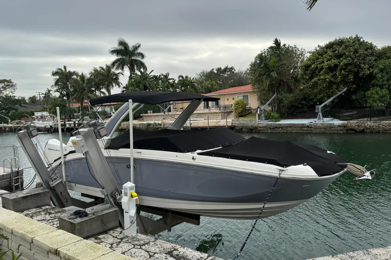  Yacht Photos Pics 2025 Sea Ray SDX 290 Outboard boat docked by a scenic waterfront.