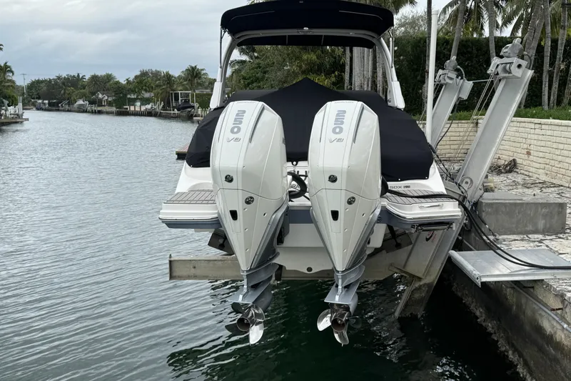  Yacht Photos Pics 2025 Sea Ray SDX 290 Outboard with twin V8 engines docked by a canal.