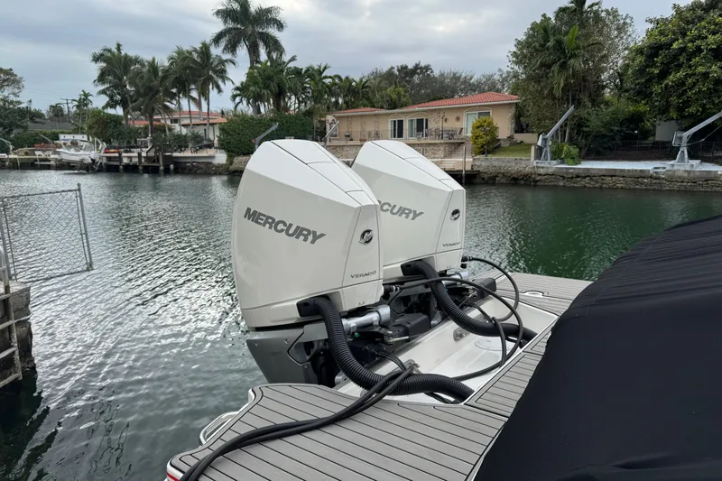  Yacht Photos Pics 2025 Sea Ray SDX 290 Outboard with twin Mercury engines docked by waterfront homes.