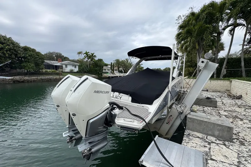  Yacht Photos Pics 2025 Sea Ray SDX 290 Outboard boat with dual Mercury engines docked by waterfront.