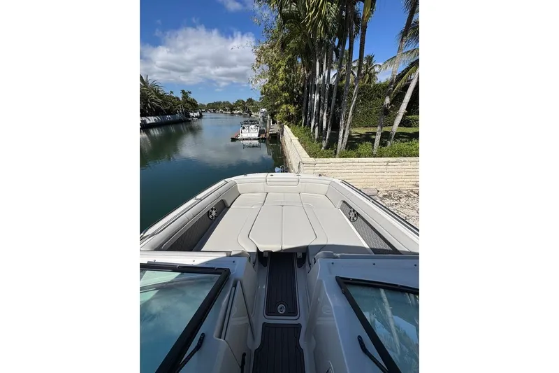 Yacht Photos Pics 2025 Sea Ray SDX 290 Outboard boat docked by a scenic canal.
