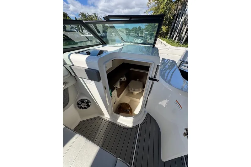  Yacht Photos Pics 2025 Sea Ray SDX 290 Outboard boat interior with open cabin door and visible toilet.