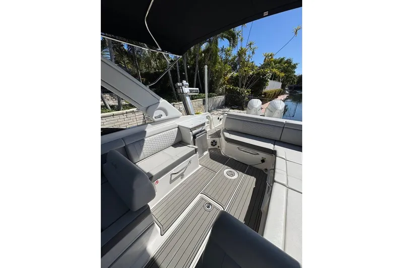  Yacht Photos Pics 2025 Sea Ray SDX 290 Outboard interior with seating and deck, under a canopy.