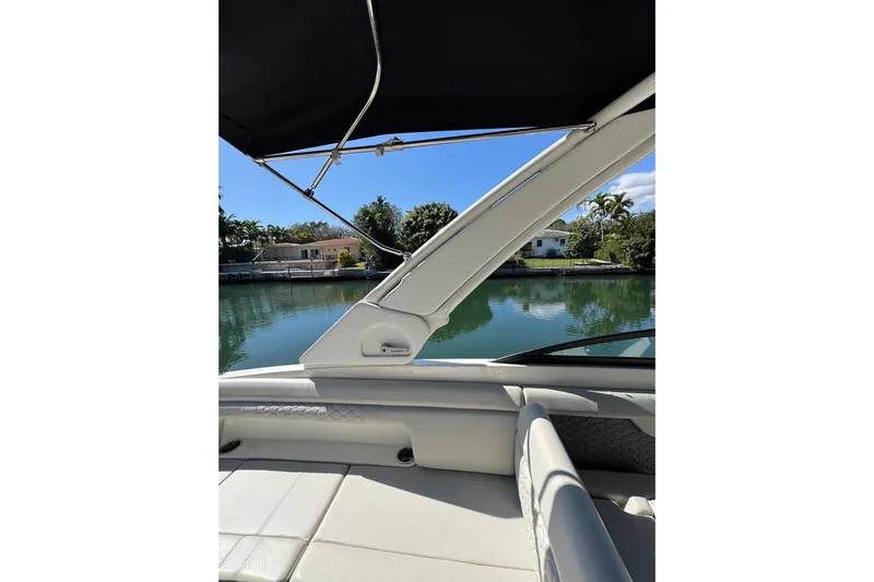 Yacht Photos Pics 2025 Sea Ray SDX 290 Outboard boat interior with water view and canopy.