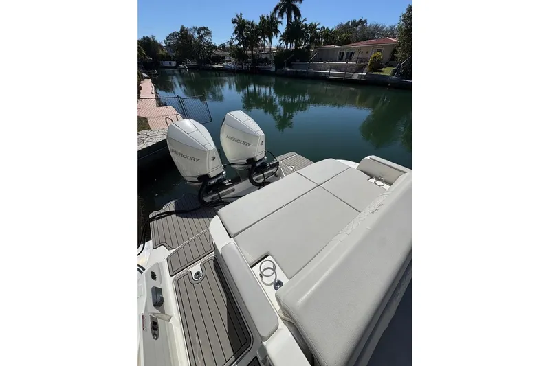  Yacht Photos Pics 2025 Sea Ray SDX 290 Outboard with dual Mercury engines on a serene waterway.