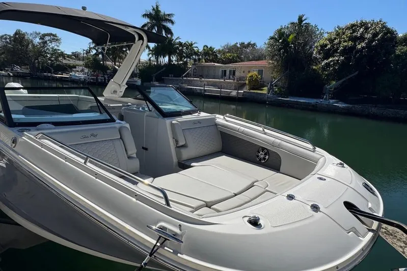  Yacht Photos Pics 2025 Sea Ray SDX 290 Outboard boat docked in a serene waterfront setting.