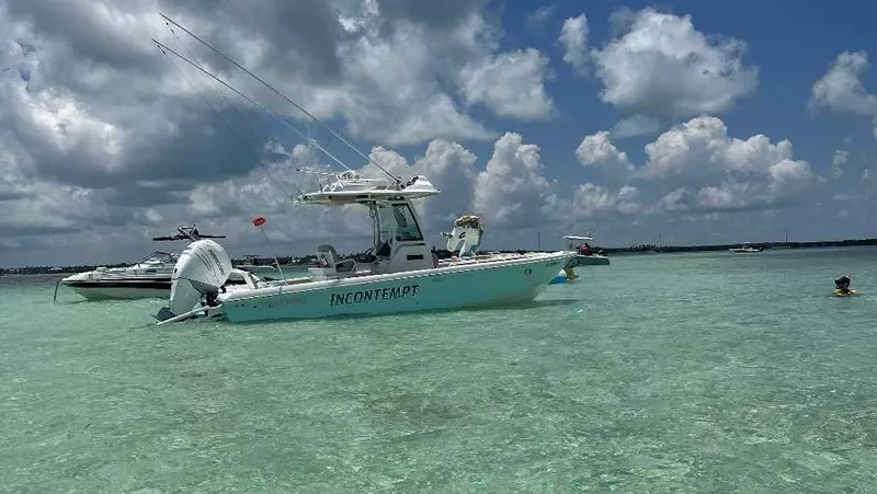 Black Label Marine Yacht Photos Pics 2021 Everglades 253 Second Station boat on clear water under cloudy sky.