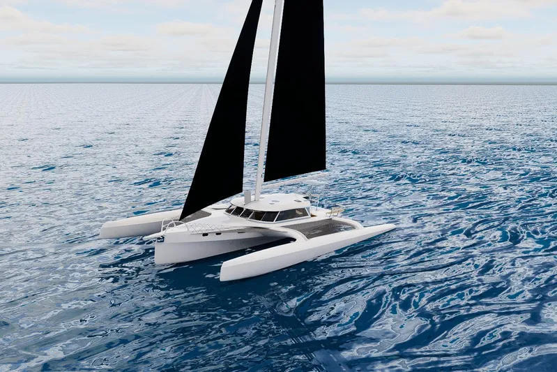  Yacht Photos Pics 2026 Rapido 63 trimaran sailing on open ocean under clear skies.