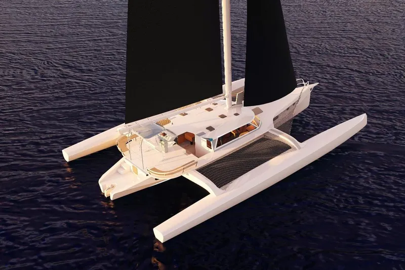  Yacht Photos Pics 2026 Rapido 63 trimaran sailing on calm waters, featuring sleek design and spacious deck.