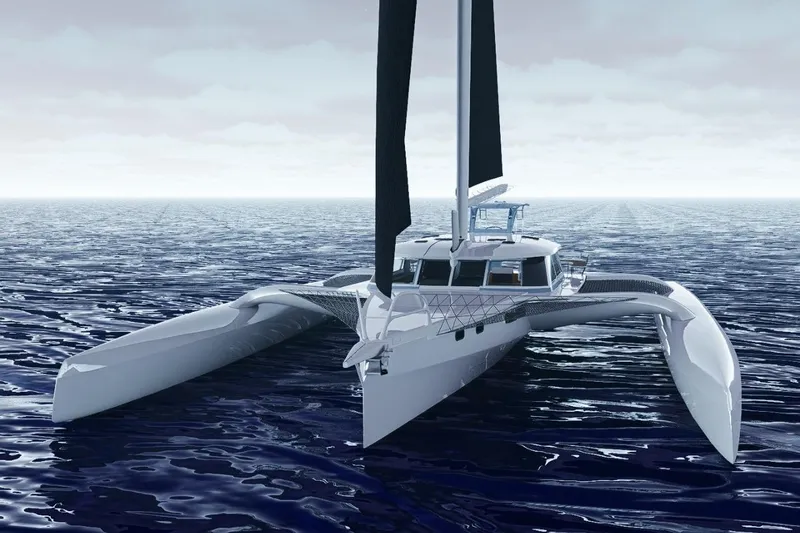  Yacht Photos Pics 2026 Rapido 63 trimaran sailing on open ocean under cloudy sky.