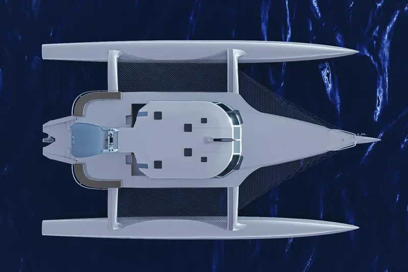  Yacht Photos Pics Top view of 2026 Rapido 63 trimaran yacht on deep blue ocean.