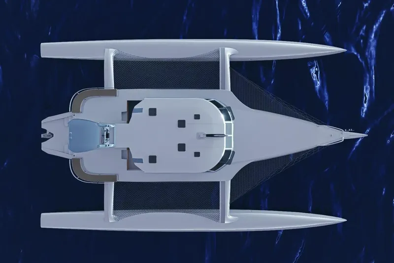  Yacht Photos Pics Top view of 2026 Rapido 63 trimaran yacht on deep blue ocean.