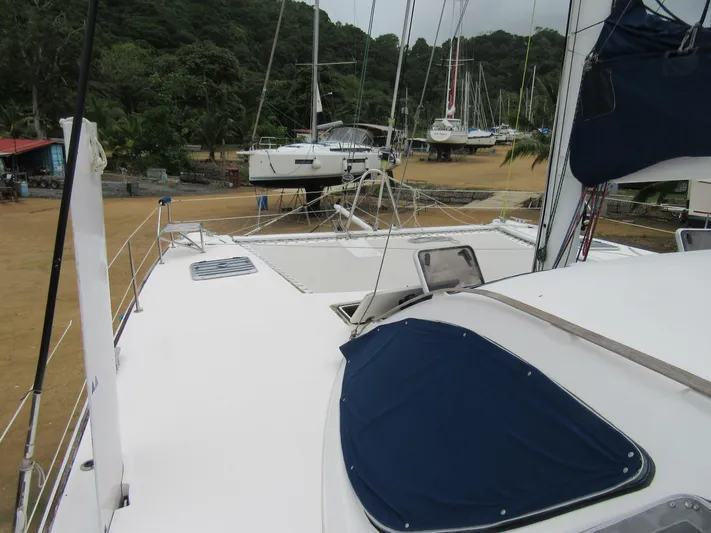 Tao Yacht Photos Pics 2005 Catana 43 Ocean Class catamaran on land, surrounded by trees and other boats.