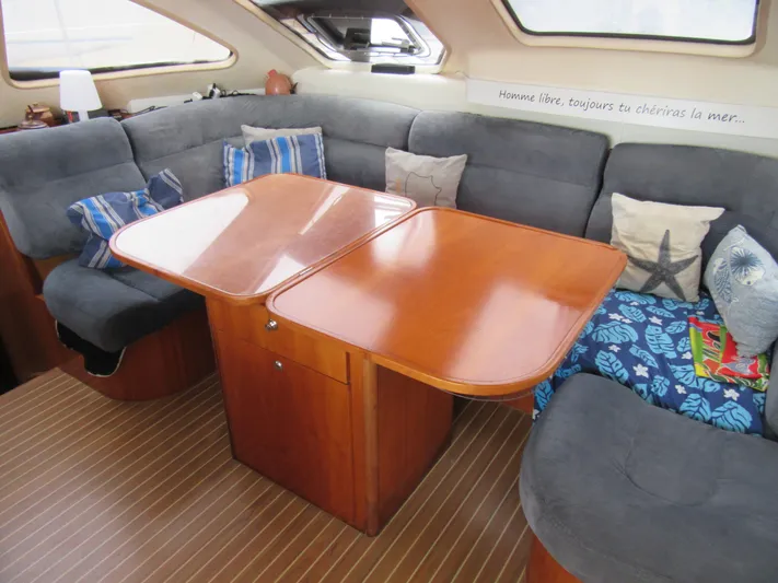 Tao Yacht Photos Pics Interior of 2005 Catana 43 Ocean Class yacht with cozy seating and wooden table.
