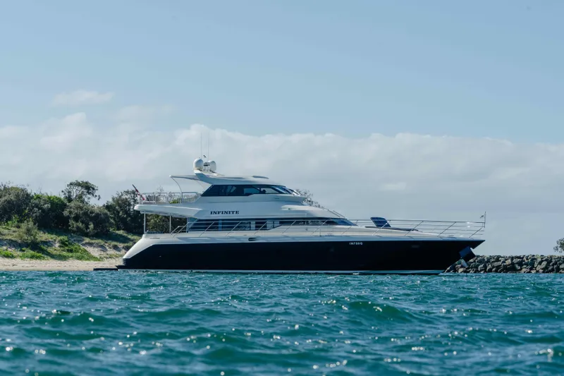 Infinite Yacht Photos Pics 1999 Warren Yachts 85 Motor Yacht on water near shoreline.