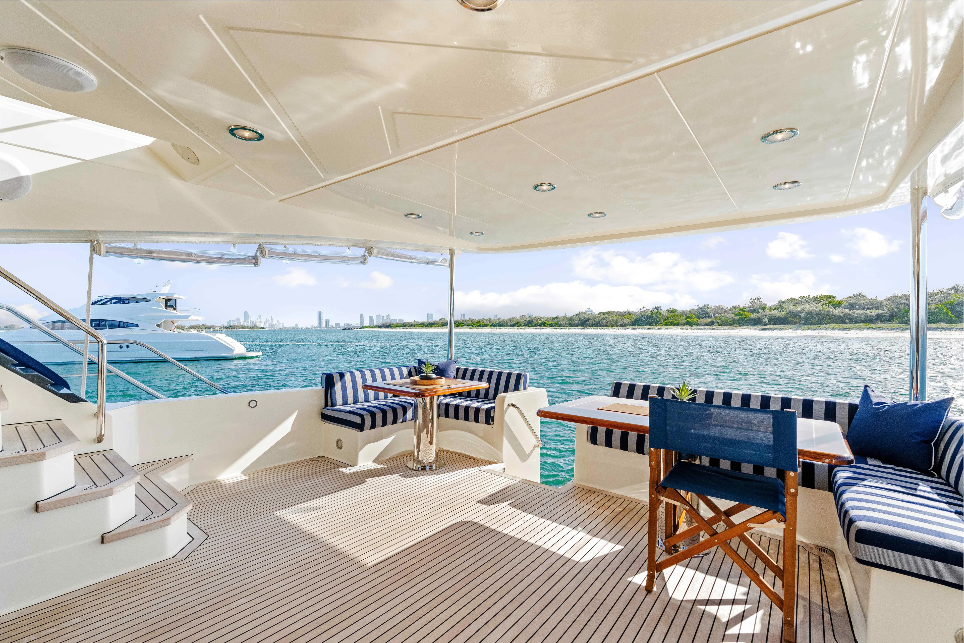 Infinite Yacht Photos Pics Spacious deck of 1999 Warren Yachts 85 Motor Yacht with seating, overlooking serene waters.