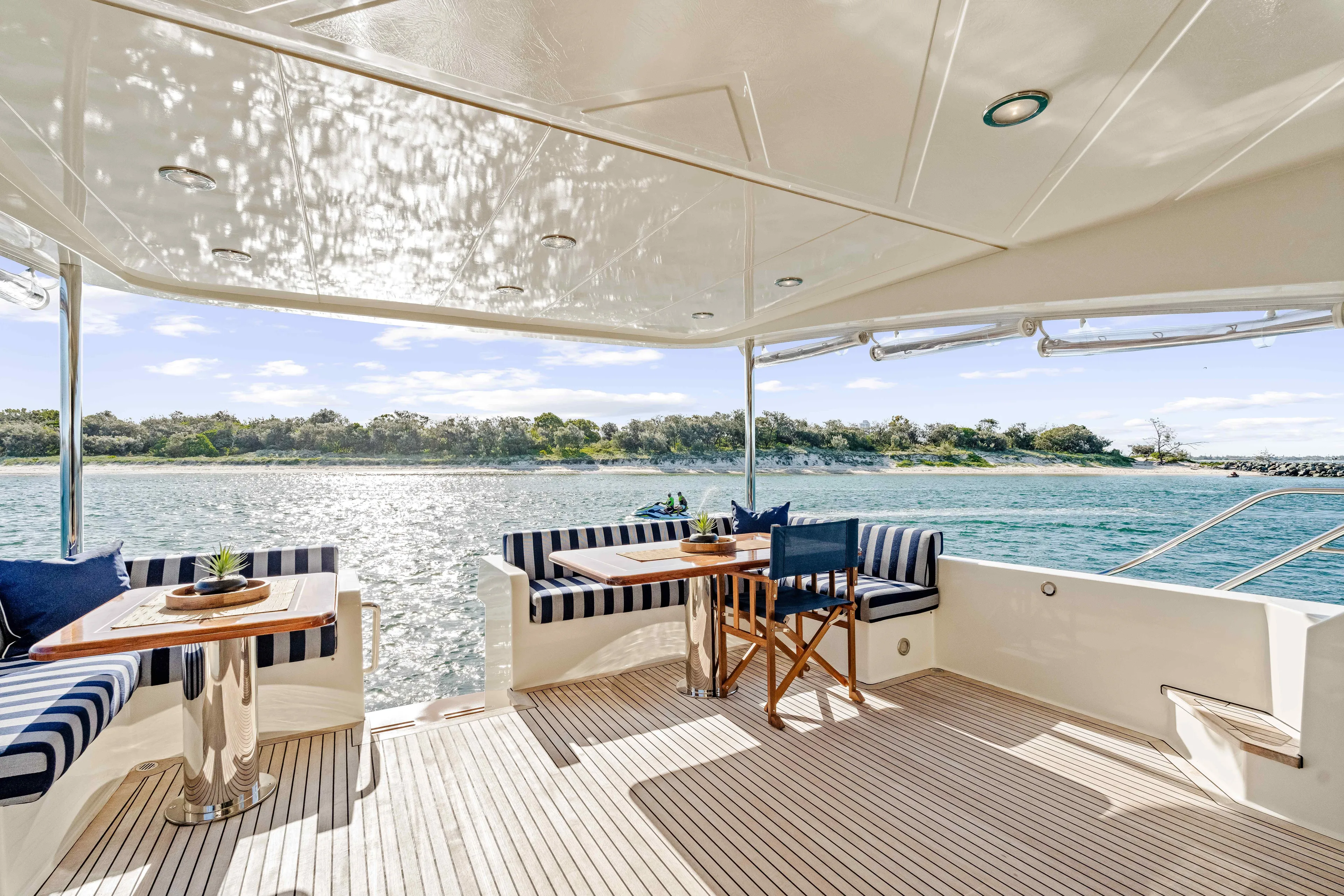 Infinite Yacht Photos Pics Luxurious 1999 Warren Yachts 85 Motor Yacht deck with seating, overlooking serene waters.