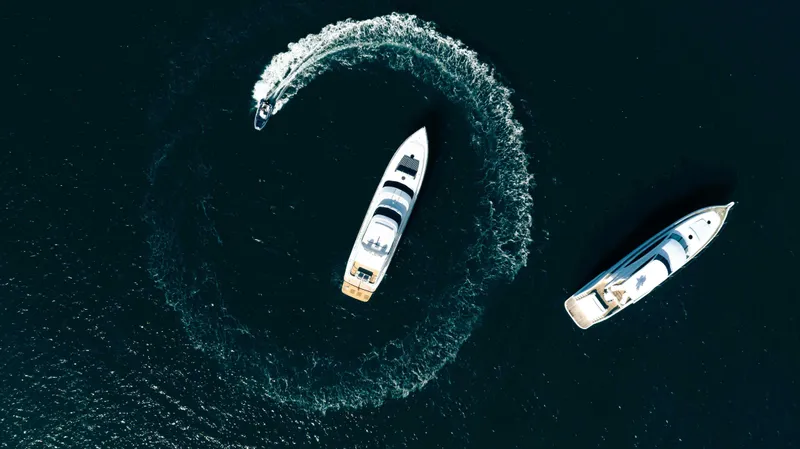 Infinite Yacht Photos Pics Aerial view of two Warren Yachts 85 Motor Yachts, 1999, cruising in open water.