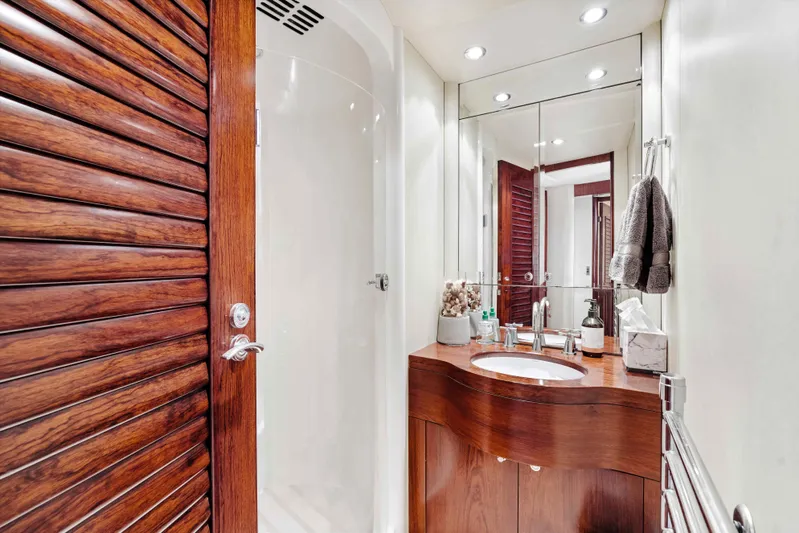 Infinite Yacht Photos Pics Luxurious bathroom on 1999 Warren Yachts 85 Motor Yacht with wooden accents and modern fixtures.