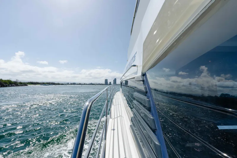 Infinite Yacht Photos Pics Side view of 1999 Warren Yachts 85 Motor Yacht cruising on open water.